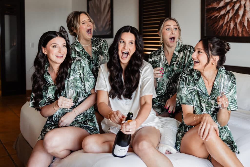 Bride and bridesmaids taking fun photos before church wedding in Cabo destination wedding.