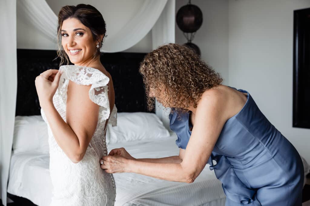 Bride getting ready with her mom for a church wedding in Cabo. Destination wedding planner