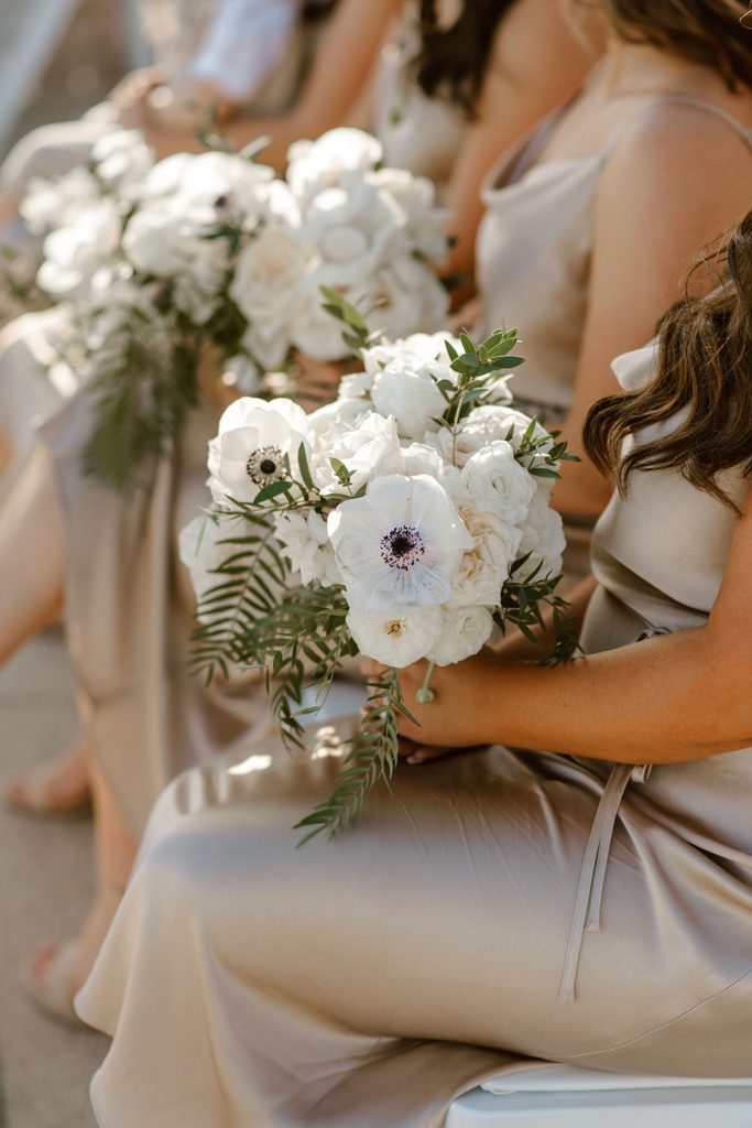 Bridesmaids bouquets with anemonas, roses, and local flowers for an elegant ceremony in los cabos